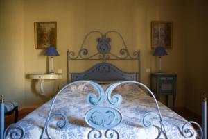 1 dormitorio con 1 cama con colcha azul y blanca en gîte Mas Antinea, en Mazan