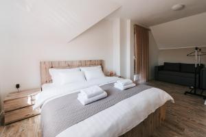 a bedroom with a large bed with two towels on it at Villa Tina in Velika