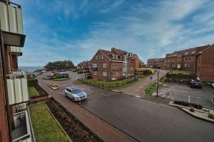 a car parked in a parking lot in a city at Wohnung-Froemming in Wittdün