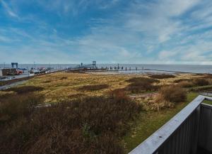 a view of a beach with the ocean in the background at Wohnung-Froemming in Wittdün +12 photos