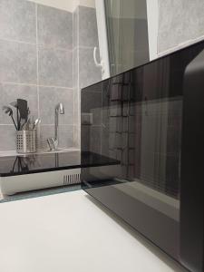 a kitchen with a microwave and a sink at Repubblica 14 in Iglesias