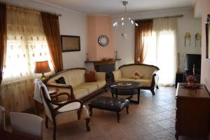 a living room with two couches and a table at Casa Milady in Sozopolis, Halkidiki in Sozopoli