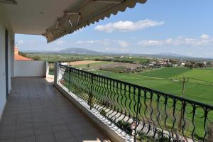 a balcony with a view of a green field at Casa Milady in Sozopolis, Halkidiki in Sozopoli