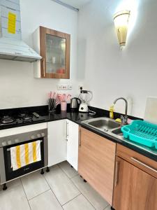 a kitchen with a sink and a stove at Sea la vie II in Kwale