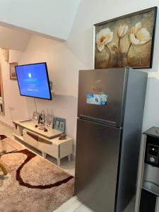 a kitchen with a refrigerator and a desk at Sea la vie II in Kwale