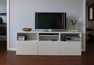 a white entertainment center with a flat screen tv at Wohnung-Kaufhold in Wittdün