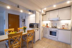 a kitchen with a table and chairs in a kitchen at Skuch-Looden in Süddorf