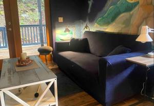 a living room with a couch and a table at Sungate on Salt Spring BnB in Salt Spring Island