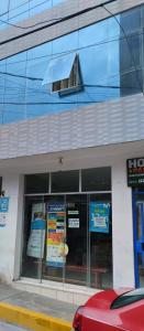 a store with signs in the windows of a building at Hostal Panoramic in Churín