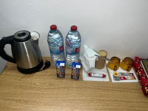 a table with a coffee pot and two water bottles at Abuawad Rental in Jerash
