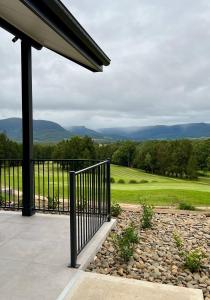 a patio with a view of a golf course at Kangaroo Valley Golf and Country Retreat in Kangaroo Valley