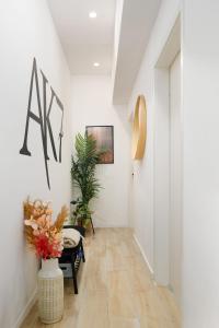 a hallway with white walls and a vase of flowers at AK7 Boutique Suites in Budapest