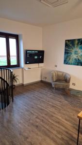 a living room with a couch and a flat screen tv at The Lake - Casa Vacanza in Dormelletto +79 photos