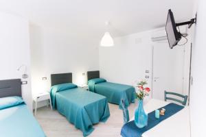 En eller flere senge i et værelse på Stanze del Mare