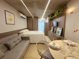 a living room with a bed and a table at Setai Yacht Premium - By Almare Flats in João Pessoa