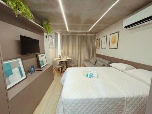 a bedroom with a large bed and a couch at Setai Yacht Premium - By Almare Flats in João Pessoa