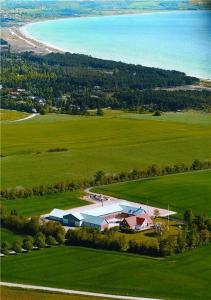 an aerial view of a house in a field next to the ocean at Beautiful Home In Ebeltoft With 3 Bedrooms in Ebeltoft