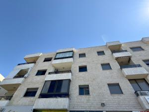 an apartment building with balconies against a blue sky at Nahr Ibrahim Suite 