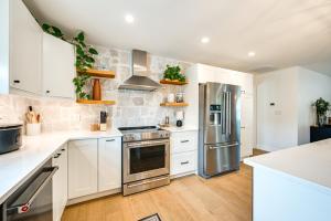 a kitchen with white cabinets and stainless steel appliances at Naples Duplex Home with Private Pool and Lanai! in Naples