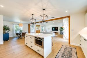 a kitchen and living room with white cabinets and a table at Naples Duplex Home with Private Pool and Lanai! in Naples