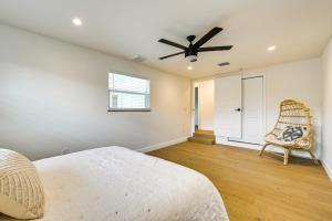 a bedroom with a ceiling fan and a chair at Naples Duplex Home with Private Pool and Lanai! in Naples