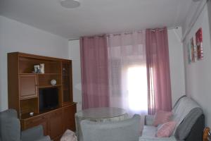 a living room with a couch and a window at Apartamento Las Fuentes in Sierra de Fuentes