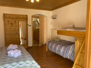 a bedroom with two bunk beds and a hallway at Casa vacanza Emi in Bocenago