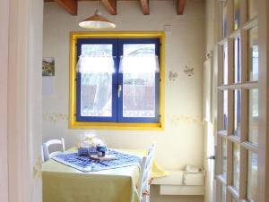 a dining room with a table and a window at Gite en Alsace in Mutzig