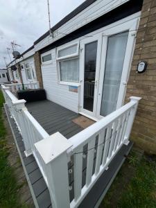 a deck on the side of a house at 288, Belle Aire, Hemsby - Beautifully presented two bed chalet, sleeps 5, pet friendly, close to beach! in Hemsby