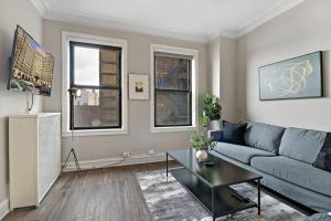 a living room with a couch and a table at Prime Studio Fully Furnished Apartment - Windermere 609 in Chicago