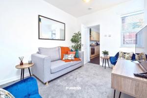 a living room with a couch and a table at Nursery House by Truestays - 3 Bedroom House in Stoke-on-Trent in Stoke on Trent