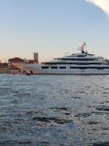 a large yacht sitting in the water near a city at #Punto FM 2# in Marghera