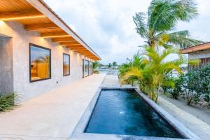 a swimming pool in the middle of a house at Seabird Luxury Dwellings in Placencia Village