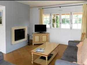 a living room with a couch and a tv at Ouasis d'éden in Tremblay-En-France