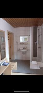 a bathroom with a shower and a sink at Hotel Anker in Rottenburg