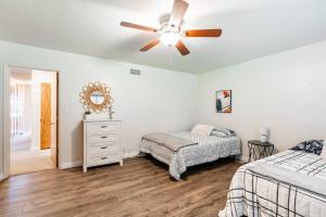 a bedroom with two beds and a ceiling fan at Casa Flora -2BR- FREE Parking in Little Italy! in San Diego