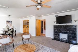 a living room with a fireplace and a flat screen tv at Casa Flora -2BR- FREE Parking in Little Italy! in San Diego