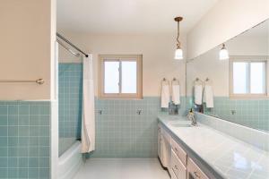 a bathroom with a sink and a shower at Casa Flora -2BR- FREE Parking in Little Italy! in San Diego +24 photos