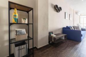 a living room with a blue couch and a mirror at 602 Private Terrace apt AC Rooftop in Mexico City