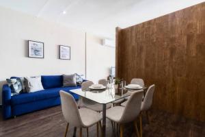 a living room with a table and a blue couch at 602 Private Terrace apt AC Rooftop in Mexico City +37 photos