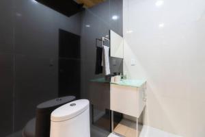 a bathroom with a white toilet and a sink at 506 Great Location AC 1Bdrm 1bath apt Rooftop in Mexico City