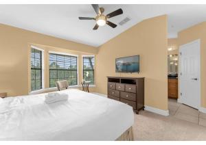 um quarto com uma cama grande e uma ventoinha de tecto em Luxurious Townhome - 5 minutes from Disney em Orlando