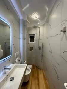 a bathroom with a sink and a toilet at Arial Lofts in Vlorë +37 photos