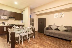 a living room with a couch and a table at 204 Historic Center 2Bdrm 2Bath AC Apt Rooftop in Mexico City