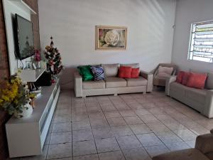 a living room with couches and a christmas tree at Casa Catuçaba in Marechal Deodoro