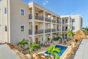 an exterior view of a building with a swimming pool at Villa Chica 3 min to Beach, Diving & Restaurants with Pool and private Garden 10 min to Windsurfing & Kitesurfing in Belnem