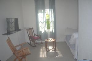 a living room with two chairs and a couch at Tropical Escape in Saint Peter