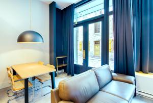 a living room with a couch and a table at Les Lofts Champlain - Par Les Lofts Vieux-Québec in Quebec City