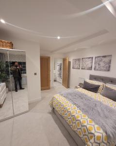 a man taking a picture of a bedroom at Luxury 2 Bed Apartment In The Heart Of Rochester in Rochester