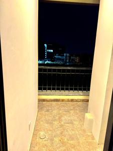 a view of a city at night from a balcony at Freddy's Deluxe Family Apartments in Islamabad